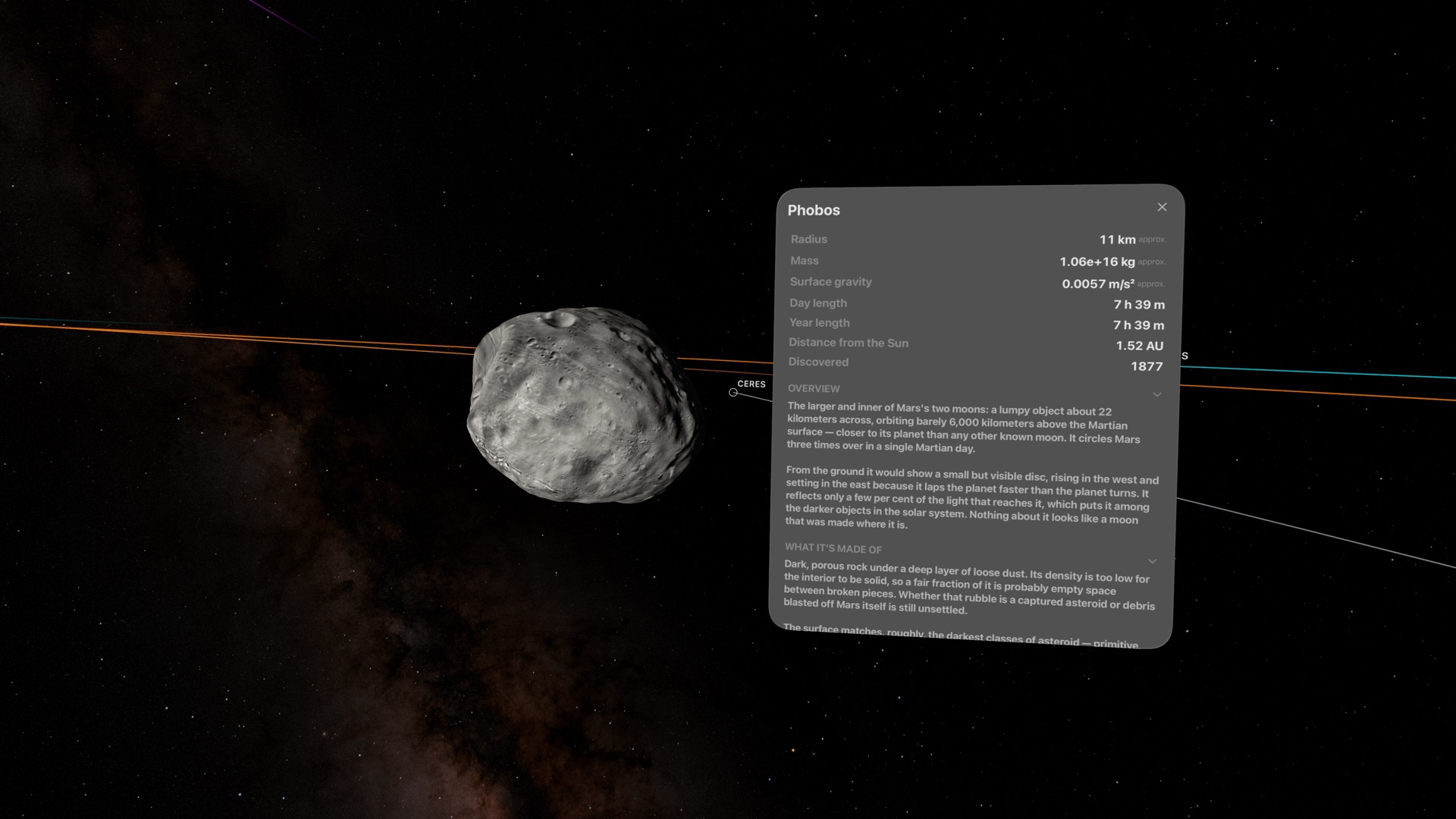 Phobos floating beside its Library panel, showing radius, mass, gravity, day length, and an overview of the moon